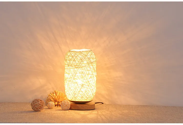 Brown hemp rope sphere desk lamp with wooden base on a desk