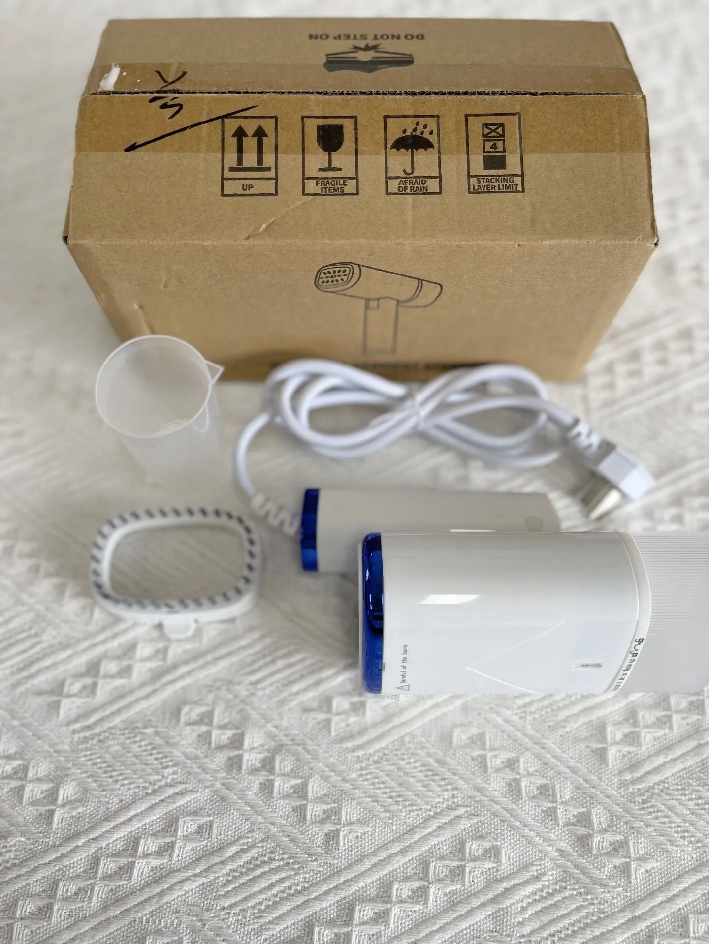Portable small household handheld garment steamer 1000W white foldable design with UK plug on a white background