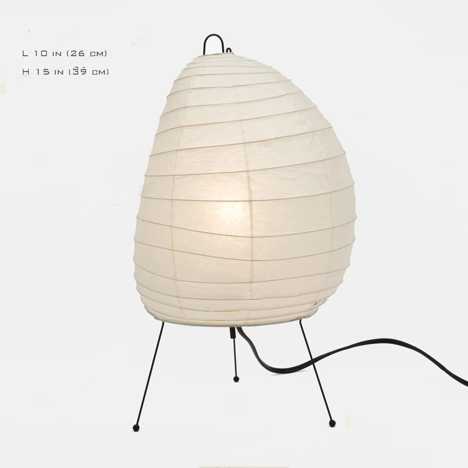 Japanese style table lamp with a white handmade rice paper lantern shade and aluminium base on a wooden table.