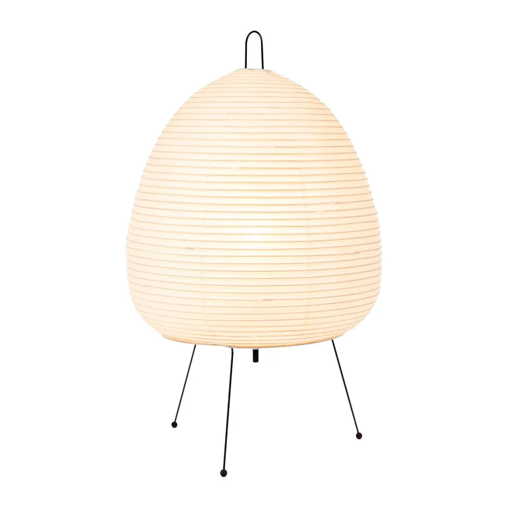 Japanese style table lamp with a white handmade rice paper lantern shade and aluminium base on a wooden table.