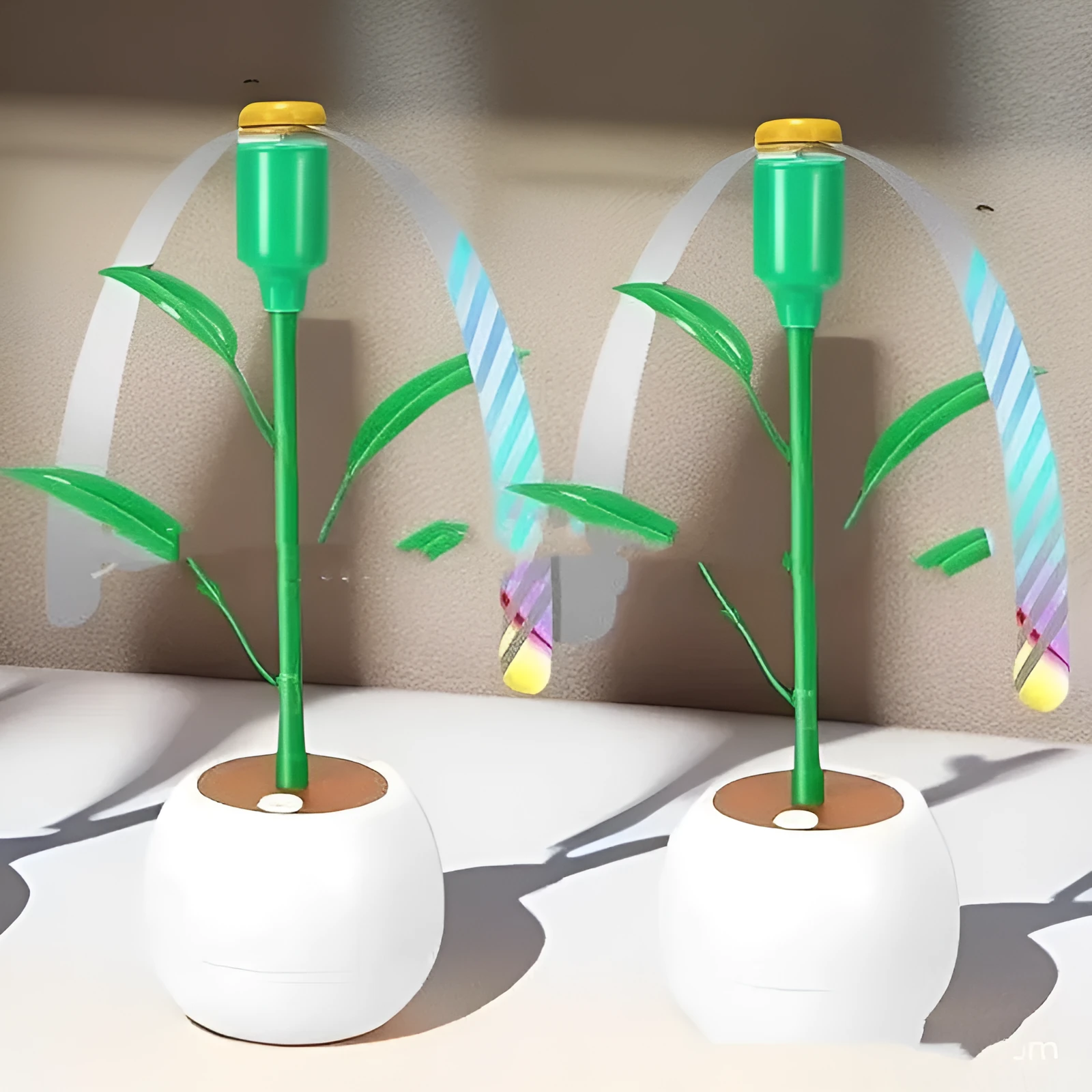 White battery fly repellent fan with curved hose and fruit-shaped design on outdoor table
