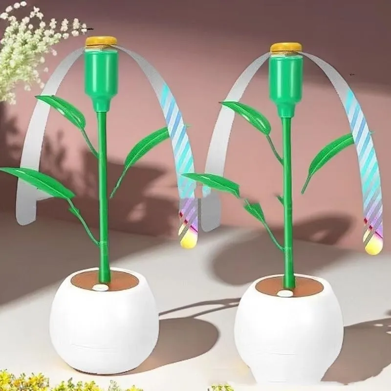 White battery fly repellent fan with curved hose and fruit-shaped design on outdoor table