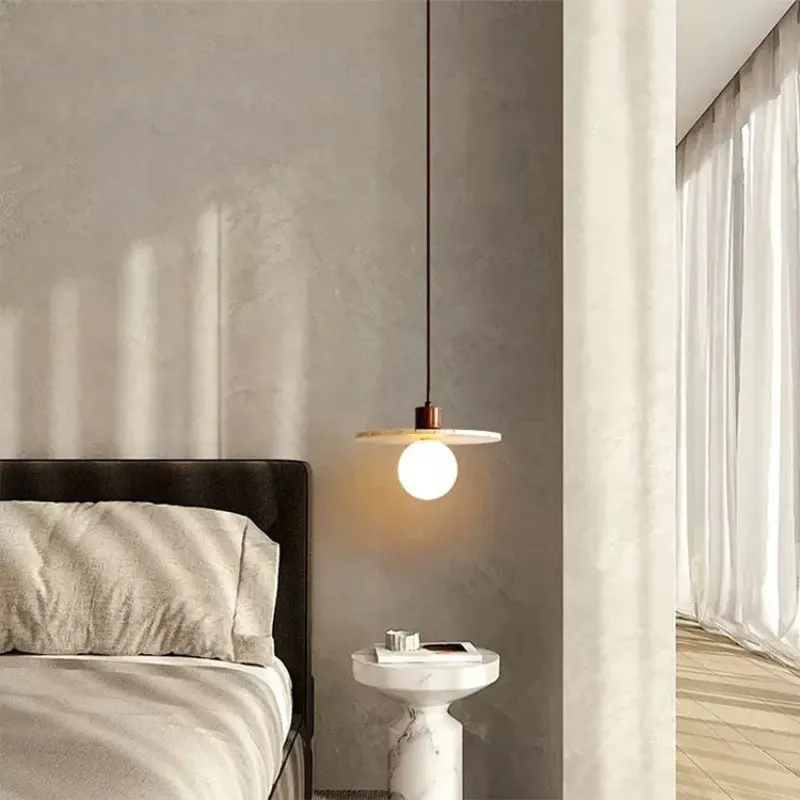 Yellow cave stone wabi sabi style marble bedside pendant light on a wooden surface
