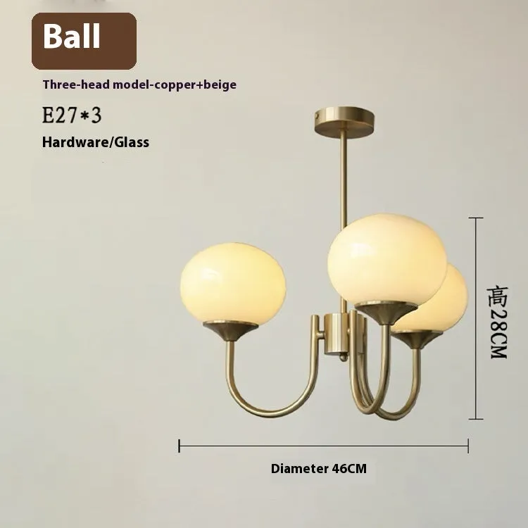 Three-head creative LED chandelier with glass lampshades and iron frame in copper pink finish for living room