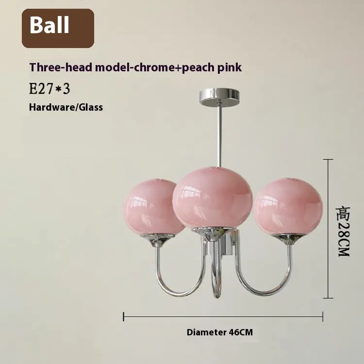 Three-head creative LED chandelier with glass lampshades and iron frame in copper pink finish for living room