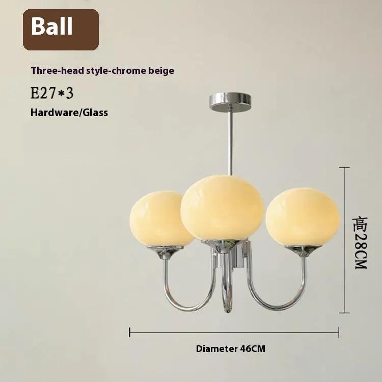 Three-head creative LED chandelier with glass lampshades and iron frame in copper pink finish for living room