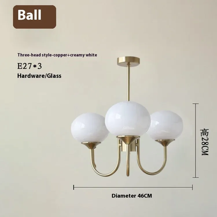 Three-head creative LED chandelier with glass lampshades and iron frame in copper pink finish for living room
