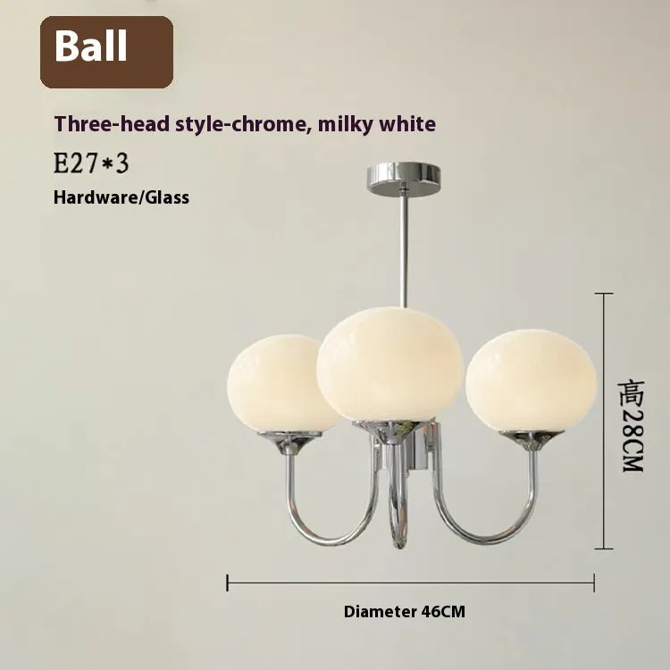 Three-head creative LED chandelier with glass lampshades and iron frame in copper pink finish for living room