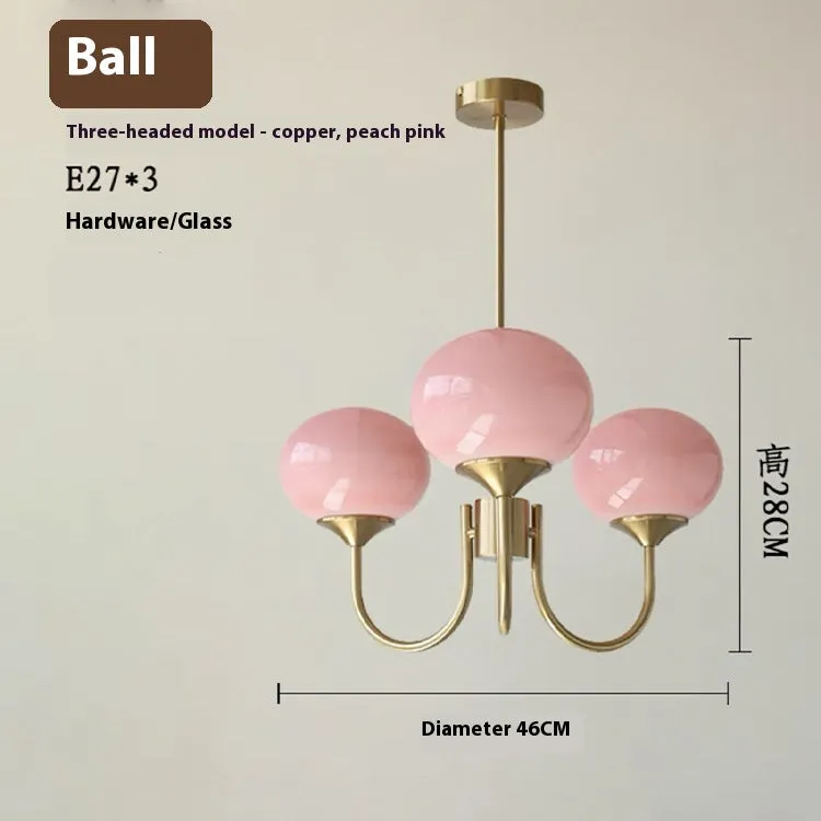Three-head creative LED chandelier with glass lampshades and iron frame in copper pink finish for living room