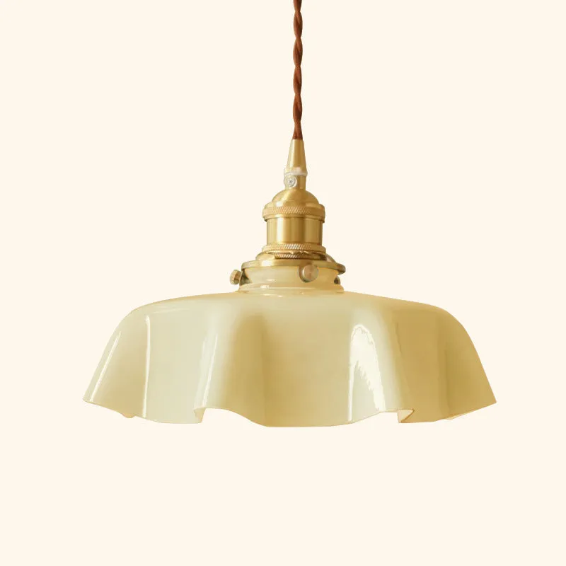 Medieval cream glass chandelier with brass flower bud design, shown with adjustable cord.