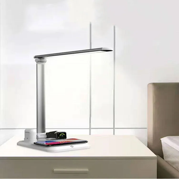 Black and white 4-in-1 LED desk lamp with integrated wireless phone charging pad visible on base