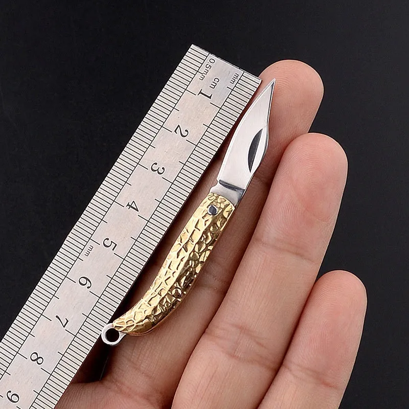 Brass mini folding knife keychain pendant with 3cm blade and 42mm shank on a key ring