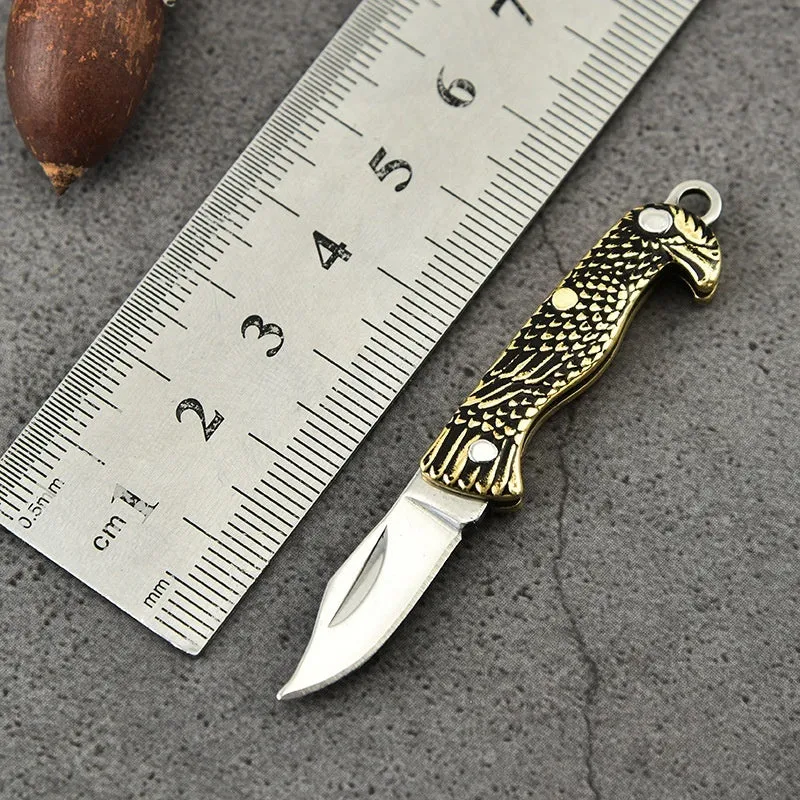 Brass mini folding knife keychain pendant with 3cm blade and 42mm shank on a key ring