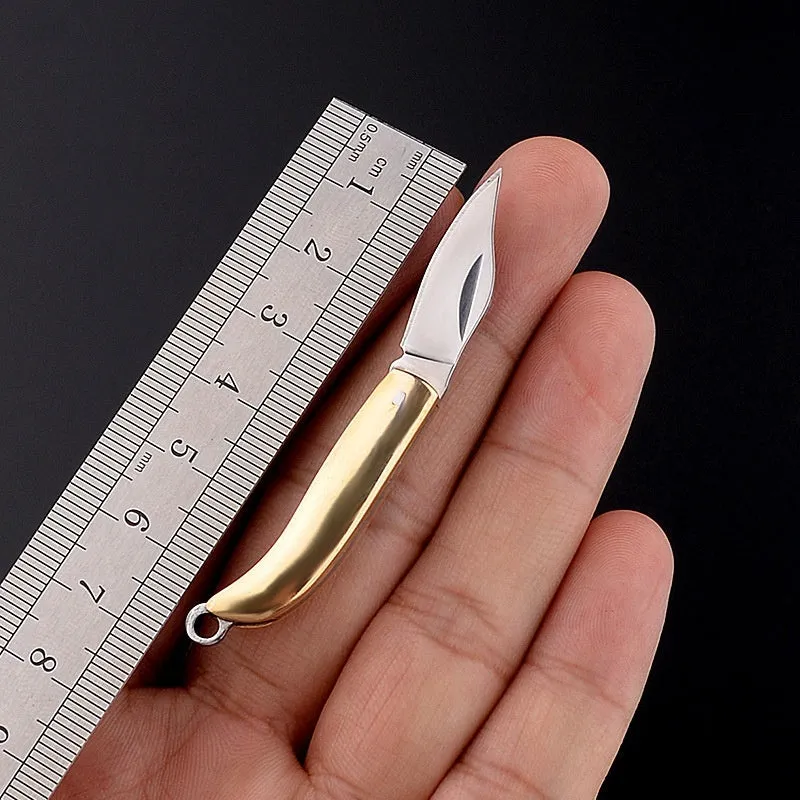Brass mini folding knife keychain pendant with 3cm blade and 42mm shank on a key ring