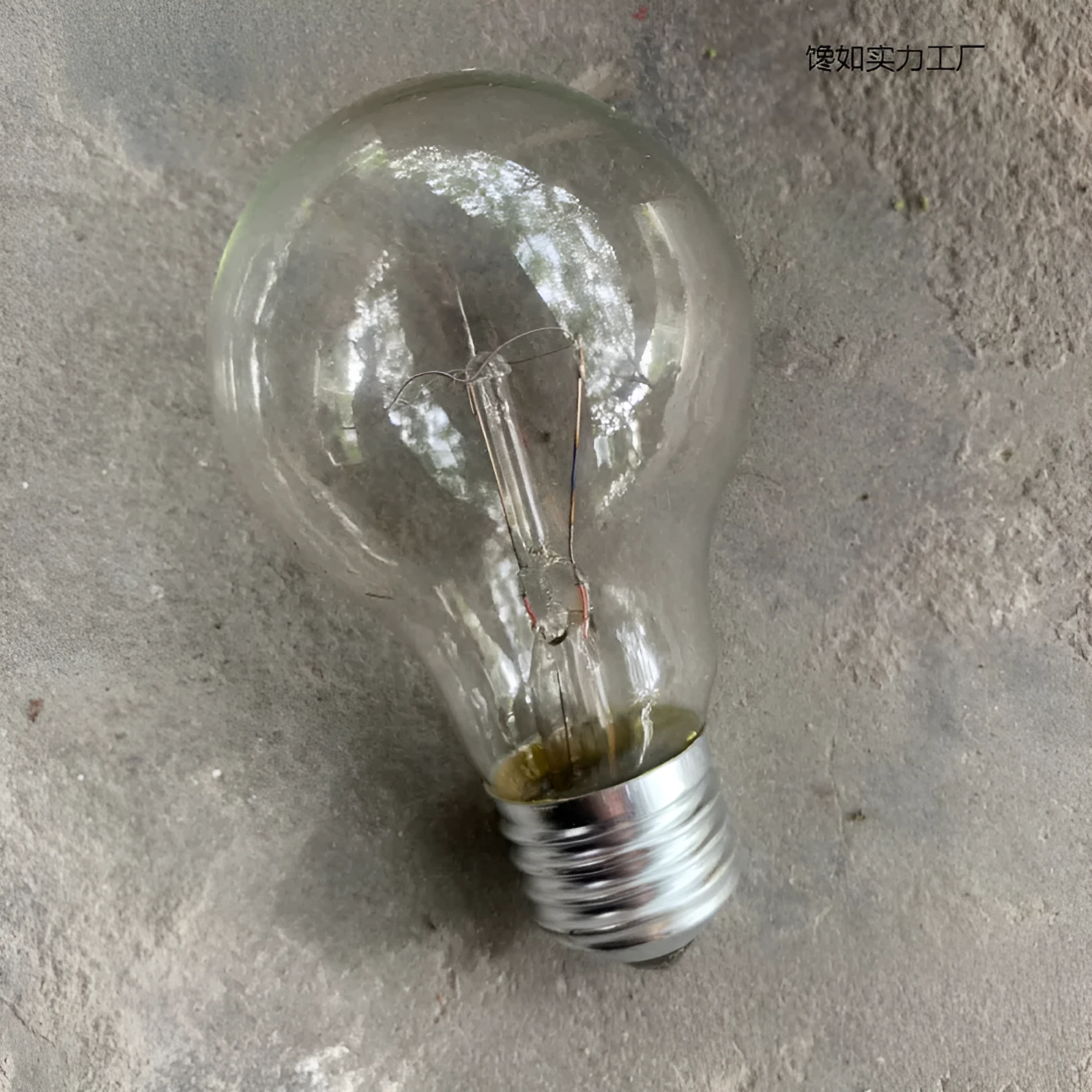 Tungsten incandescent household bulb with E27 screw base, clear glass, and visible filament