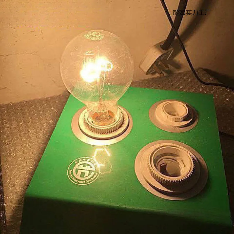 Tungsten incandescent household bulb with E27 screw base, clear glass, and visible filament