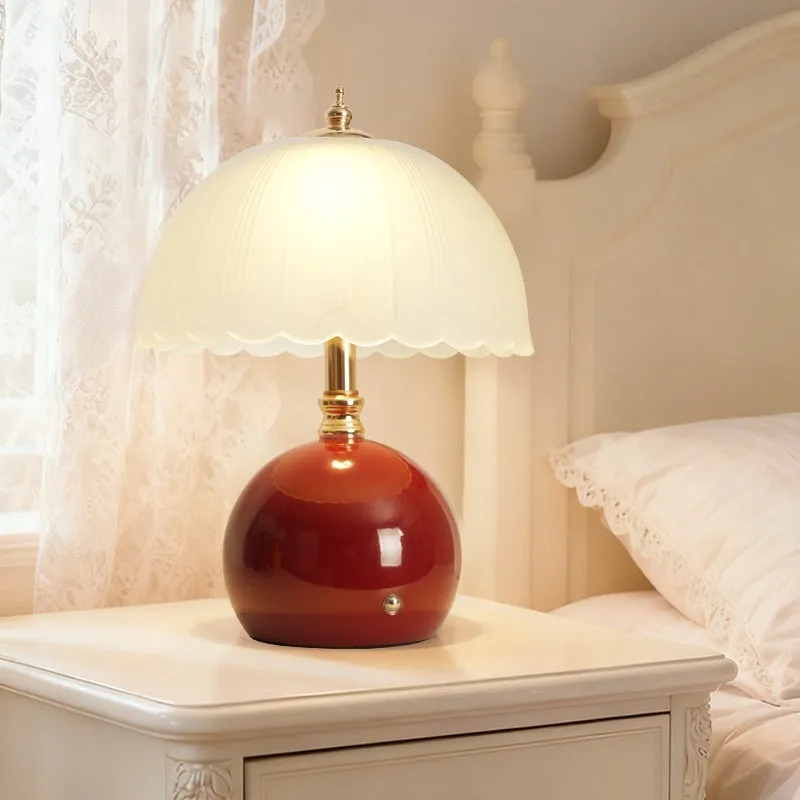 Geometric 3D table lamp in black with warm light on a wooden side table in a modern living room