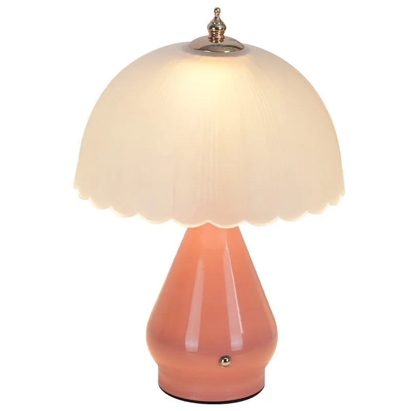 Geometric 3D table lamp in black with warm light on a wooden side table in a modern living room