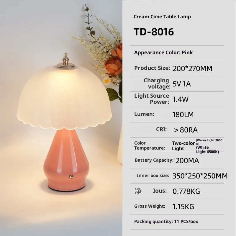 Geometric 3D table lamp in black with warm light on a wooden side table in a modern living room