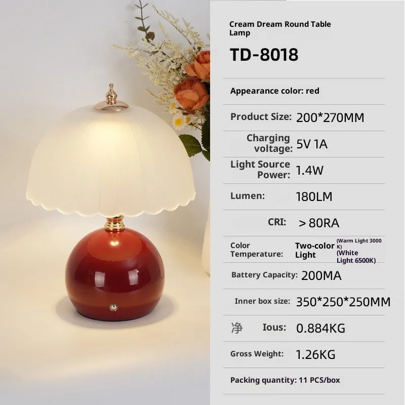 Geometric 3D table lamp in black with warm light on a wooden side table in a modern living room