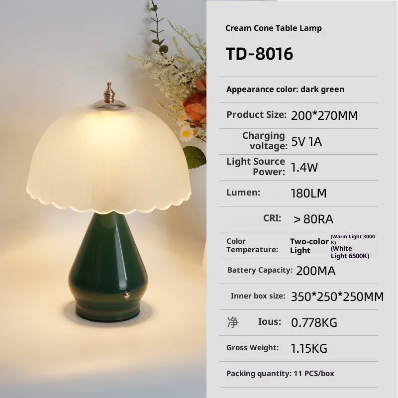 Geometric 3D table lamp in black with warm light on a wooden side table in a modern living room