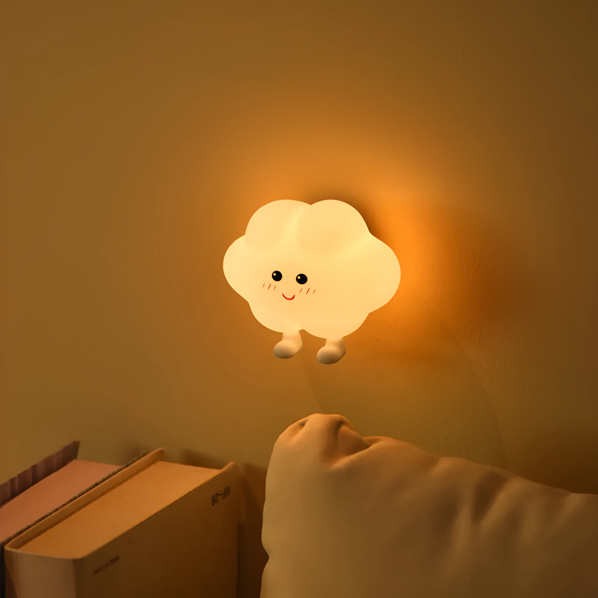 Moon XINGX Cloud silicone lamp with warm light, magnetic suction base, and cartoon design on a bedside table