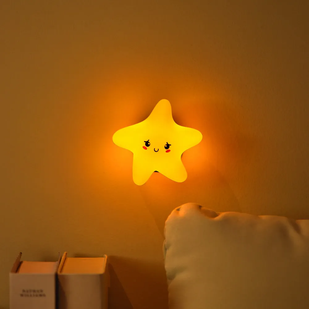 Moon XINGX Cloud silicone lamp with warm light, magnetic suction base, and cartoon design on a bedside table