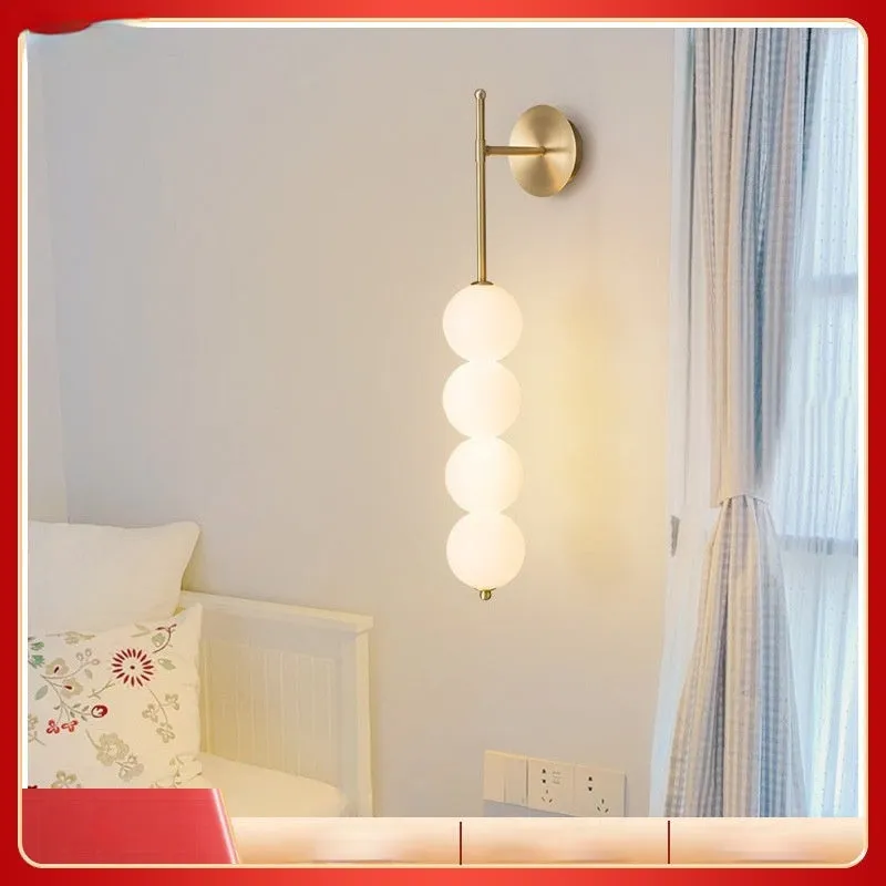Nordic wall lamp in gold finish with tricolour light, rotomoulded construction for bedside atmosphere