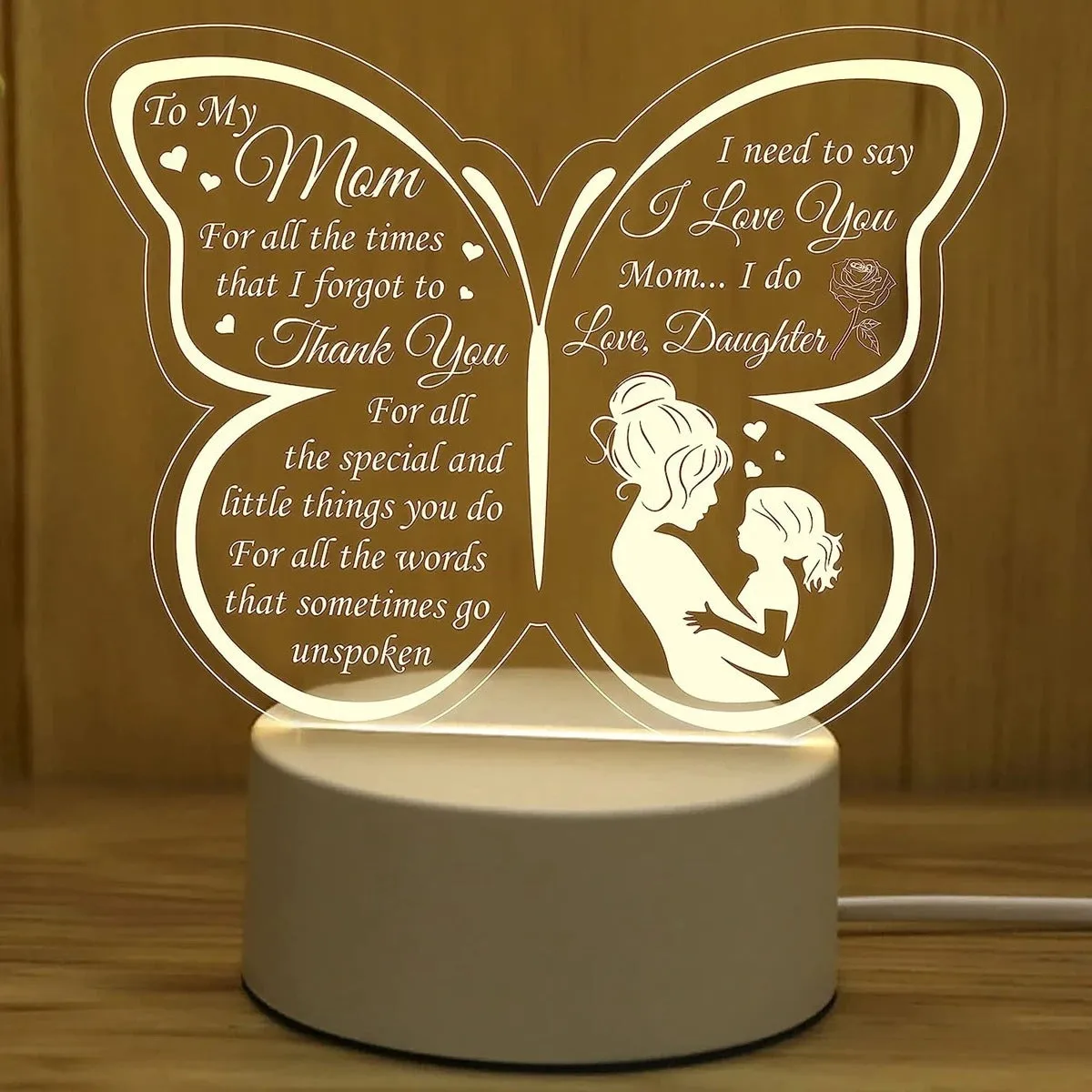 White heart-shaped acrylic table lamp with touch switch on a wooden surface.
