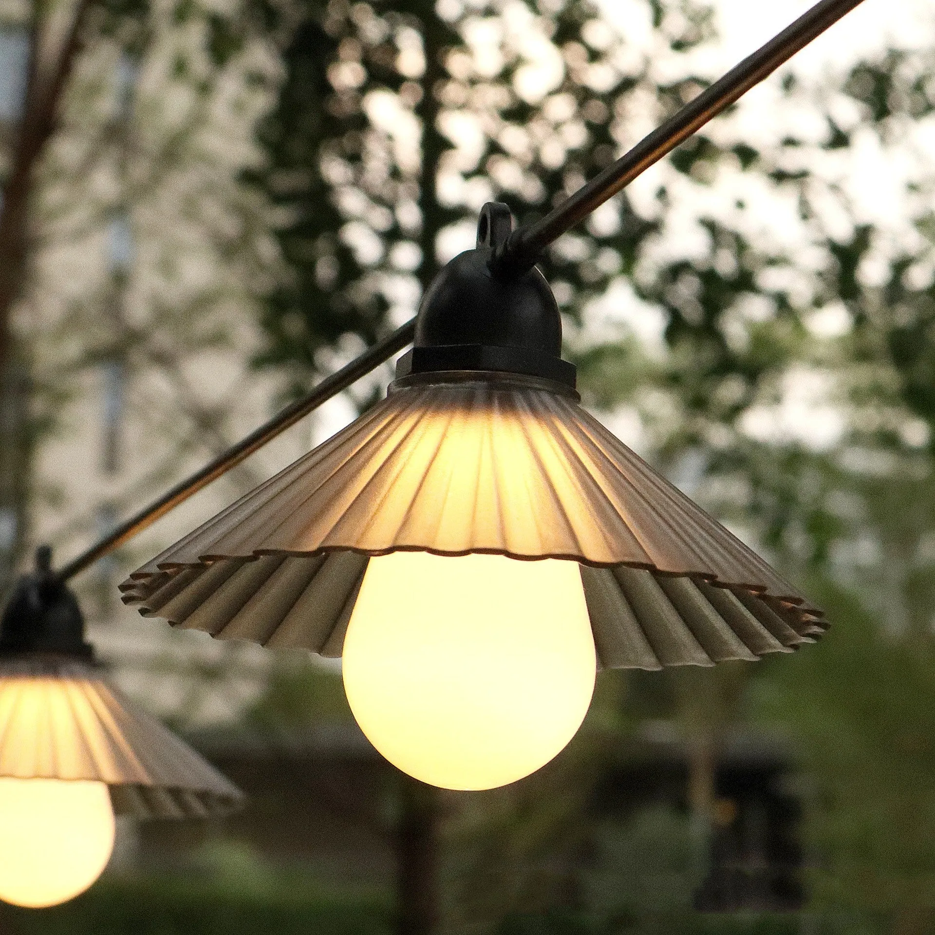 Outdoor LED string lights with flower-shaped bulbs in four colours or warm white, IP65 rated.