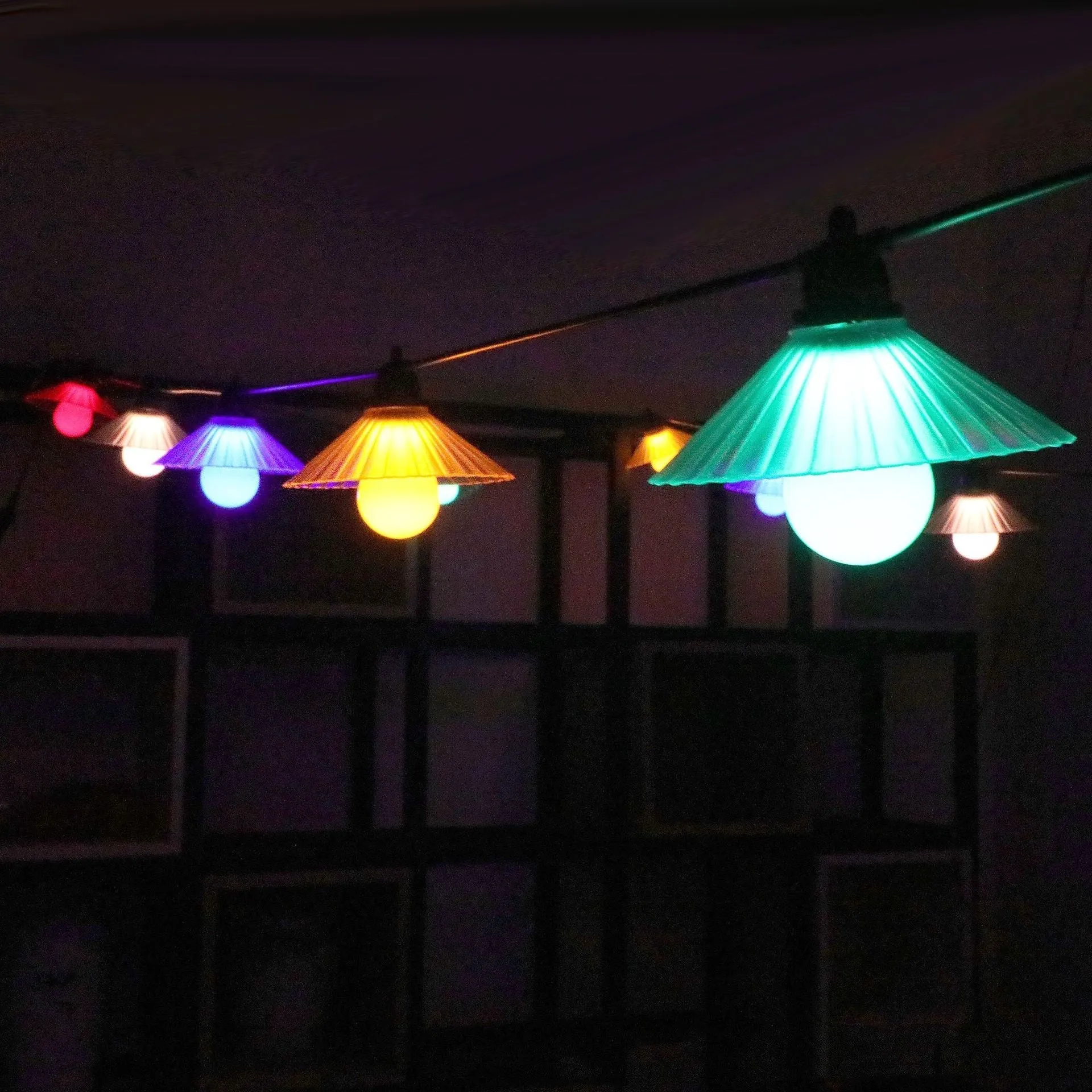 Outdoor LED string lights with flower-shaped bulbs in four colours or warm white, IP65 rated.