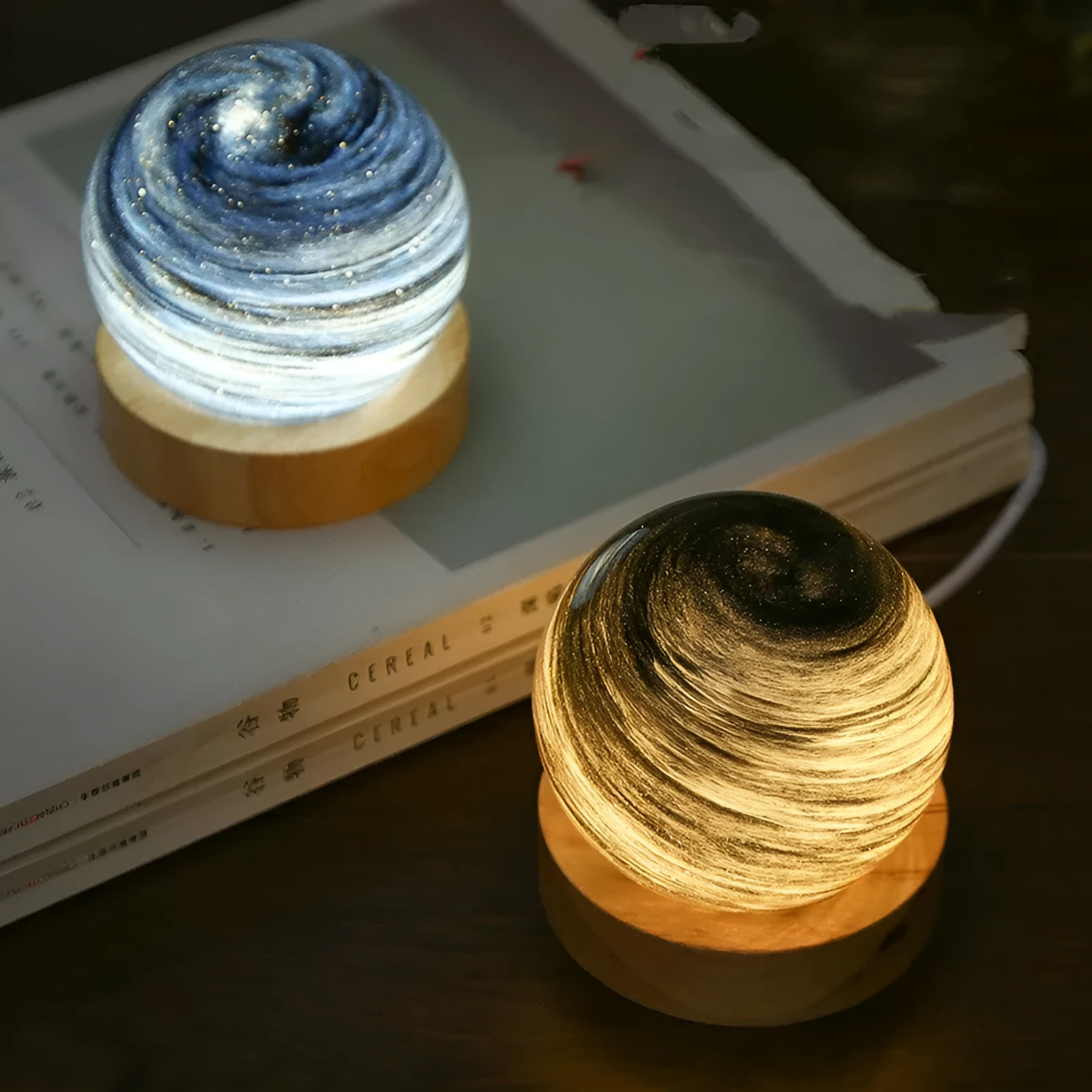 Modern planet-shaped USB night light with dimming on a desk.
