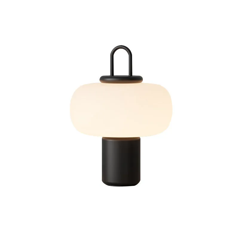 Minimalist Japanese designer glass bedside table lamp with warm light for a child's room.