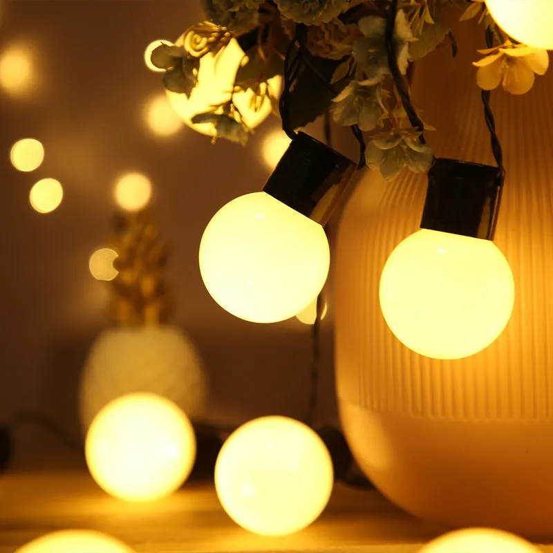 10 metre solar powered decorative festoon lights with 40 LED bulbs for festival tents in black with warm white LEDs