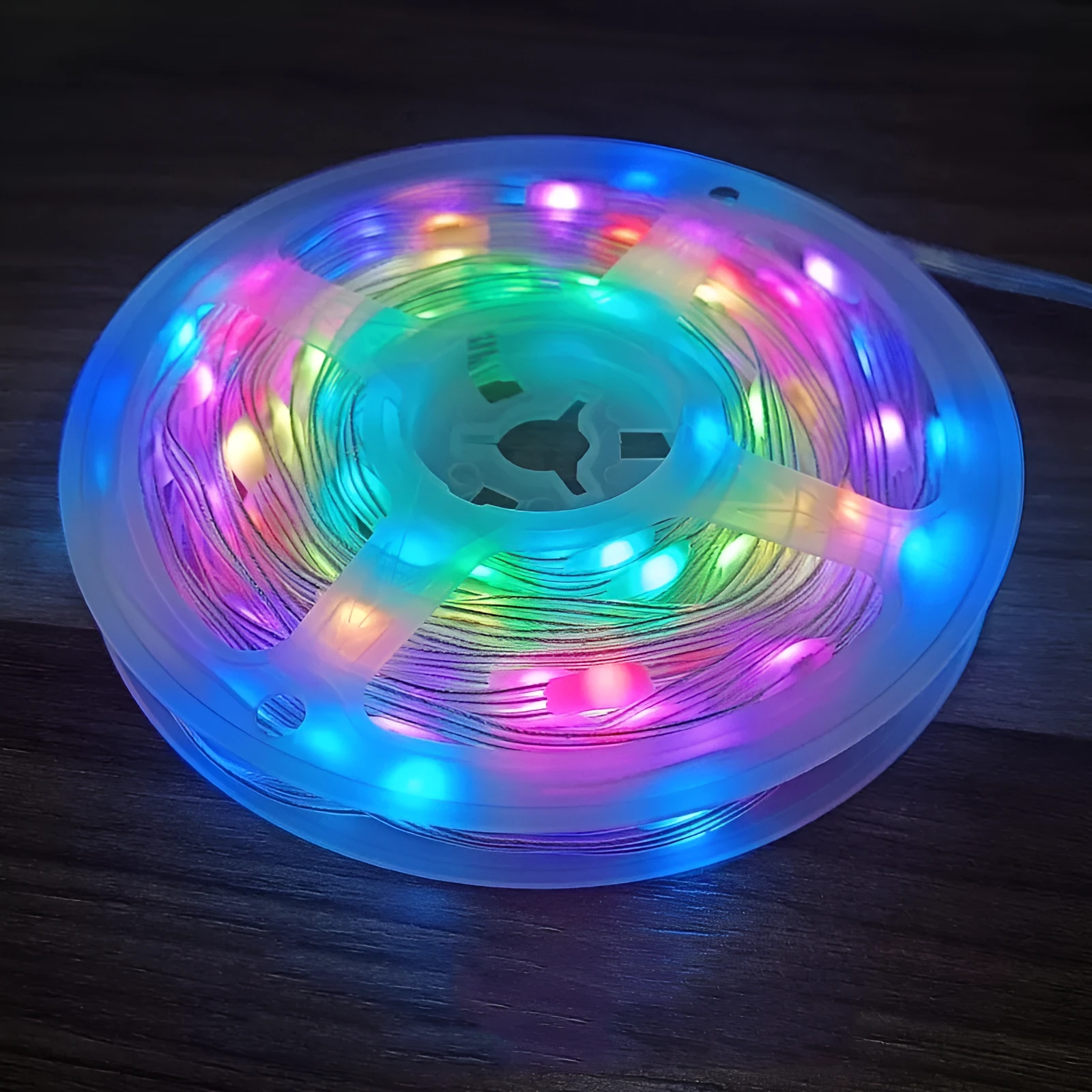 10-metre long flexible LED light string with 100 multi-colour bulbs lit up in a garden setting.