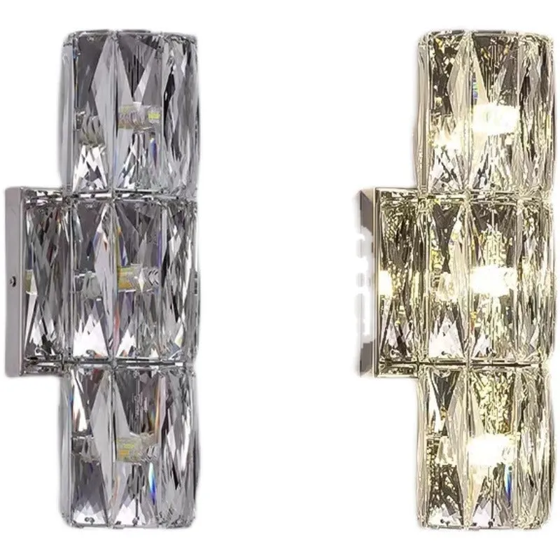 A sleek crystal wall lamp with a stainless steel base in chrome finish, mounted on a wall.