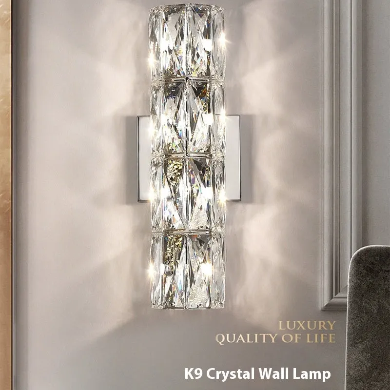 A sleek crystal wall lamp with a stainless steel base in chrome finish, mounted on a wall.