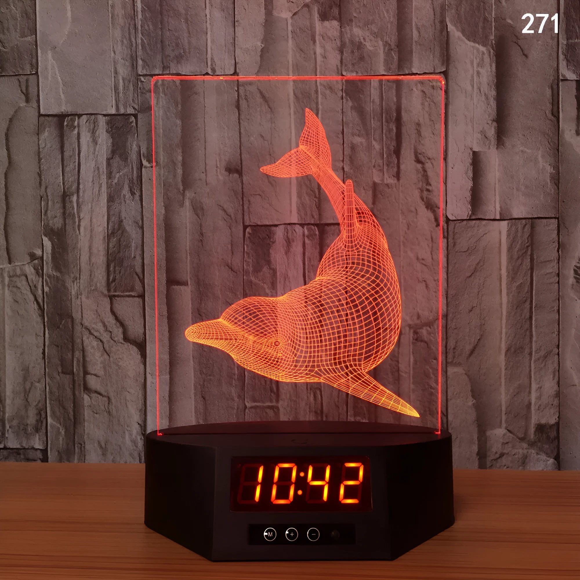 Dolphin-shaped 3D night light table lamp with wireless charging pad and remote control on wooden surface