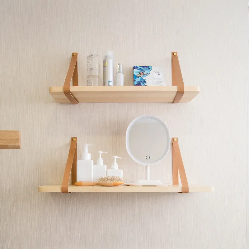 Pine wood wall-mounted storage shelf, 50cm wide by 16cm high, holding books and cosmetic items.