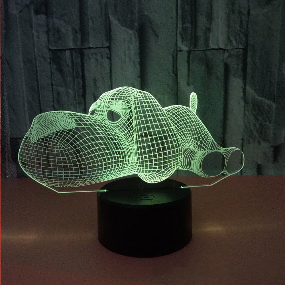 Doggo shaped 3D illusion desktop lamp glowing in multiple colours on a desk.