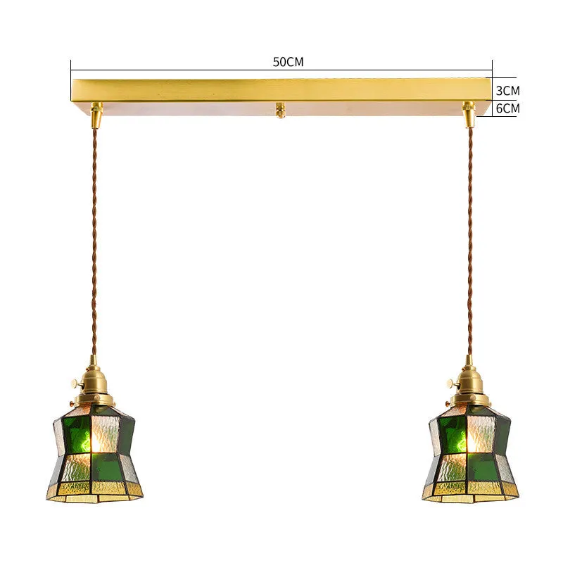 Retro brass and hand-blown glass chandelier with a hemp rope light line hanging from a ceiling.