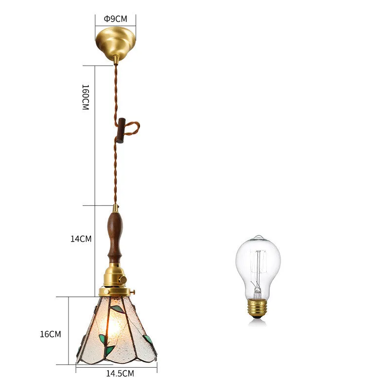 Retro brass and hand-blown glass chandelier with a hemp rope light line hanging from a ceiling.