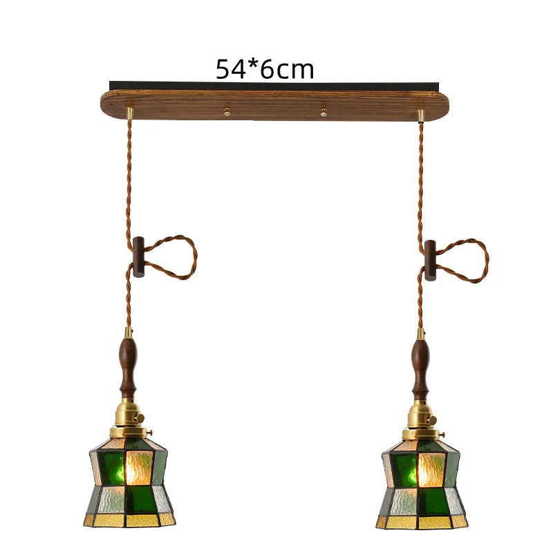 Retro brass and hand-blown glass chandelier with a hemp rope light line hanging from a ceiling.