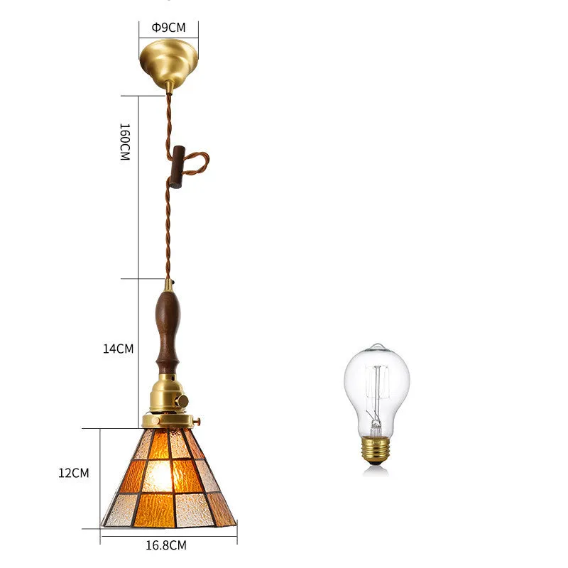 Retro brass and hand-blown glass chandelier with a hemp rope light line hanging from a ceiling.