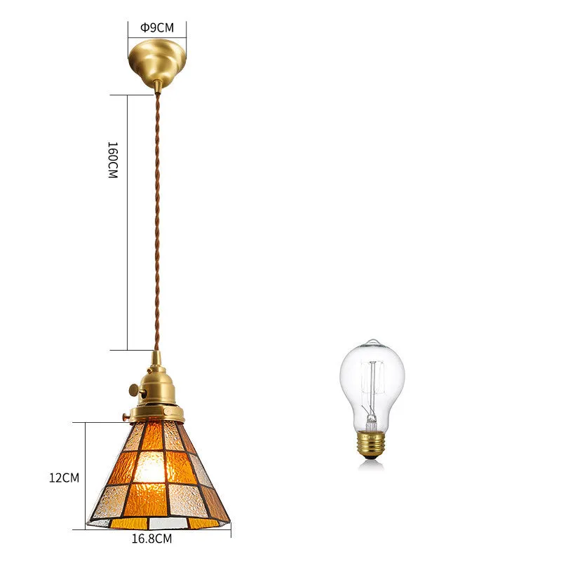 Retro brass and hand-blown glass chandelier with a hemp rope light line hanging from a ceiling.