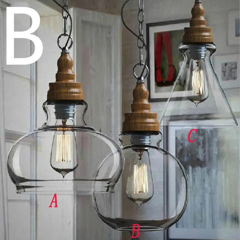 Single head glass pendant light with wood grain finish hanging from ceiling on adjustable cable.