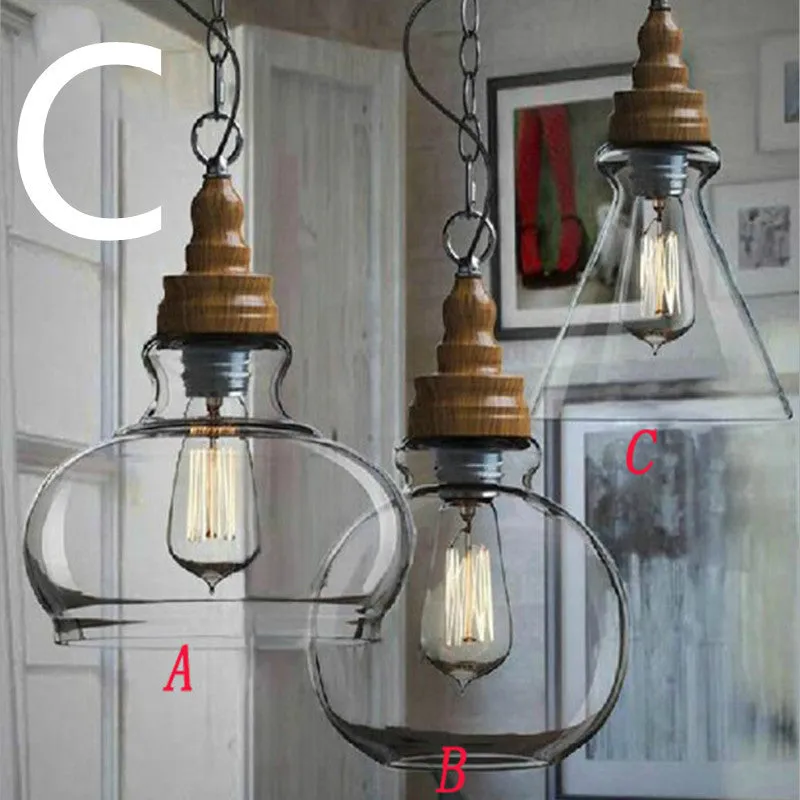 Single head glass pendant light with wood grain finish hanging from ceiling on adjustable cable.