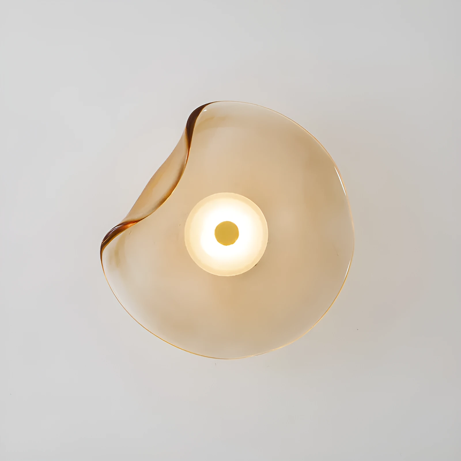 Round glass wall lamp for bedroom bedside in cognac, grey or light colour finishes.