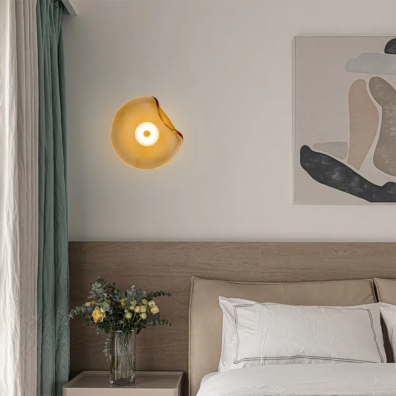 Round glass wall lamp for bedroom bedside in cognac, grey or light colour finishes.