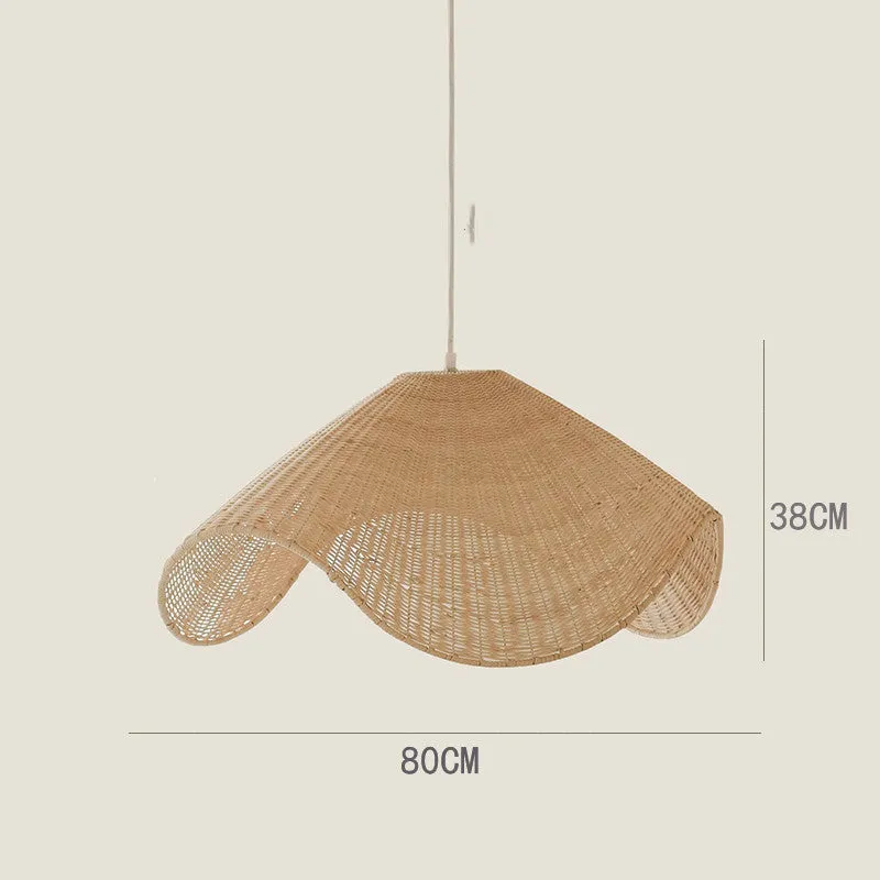 Handmade bamboo rattan chandelier with woven straw and willow lampshade in warm light